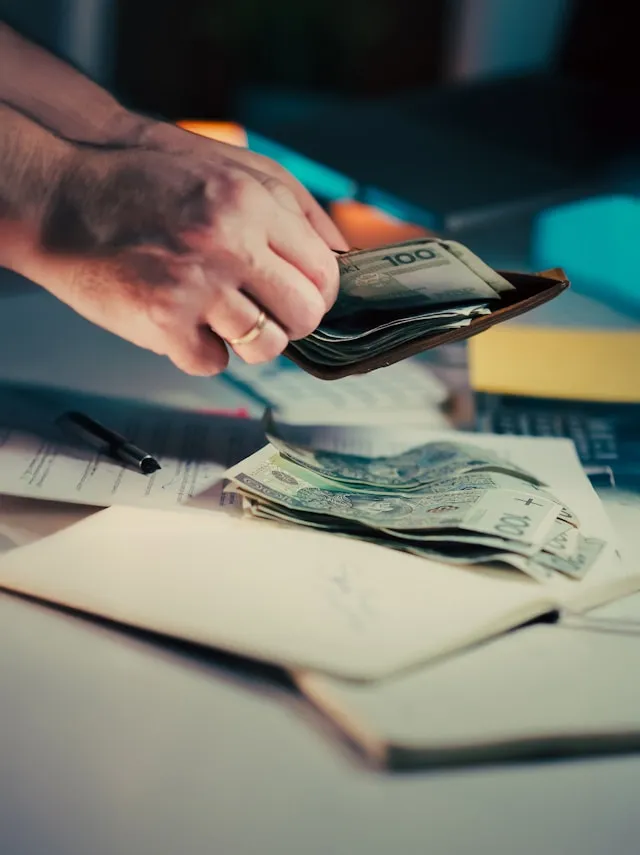 Person tearing up a contract document at a desk