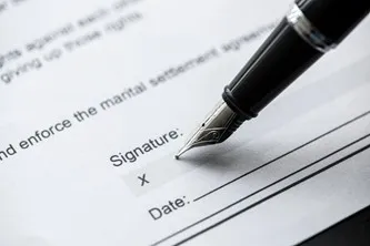 Pen signing a document with signature and date fields