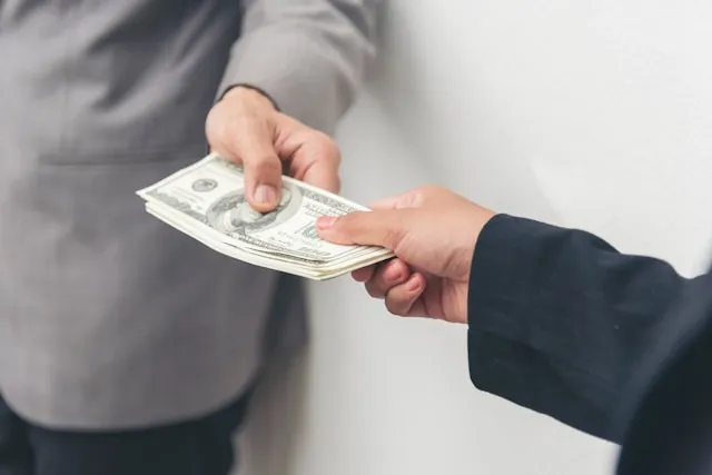 A person comparing interest rates and discount rates on financial documents