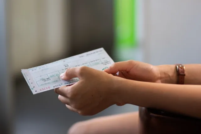 Lottery balls and cash representing a jackpot payout decision