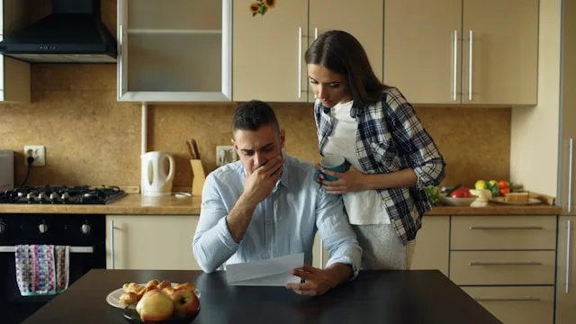 Couple reviewing financial documents while considering whether to sell structured settlement payments