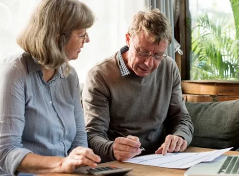 Couple reviewing structured settlement documents together at home