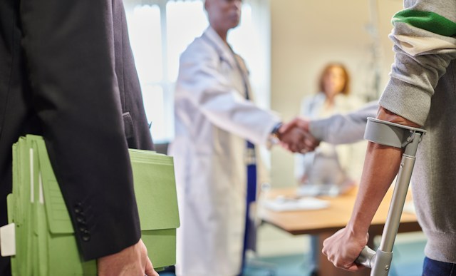 Injury settlement documents being reviewed by legal professionals